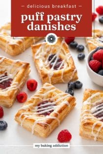 Puff pastry danishes scattered on a white countertop with mixed fresh berries. Text overlay includes recipe name.