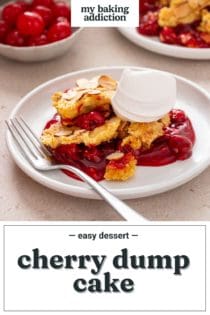 Serving of cherry dump cake next to a fork on a white plate. Text overlay includes recipe name.