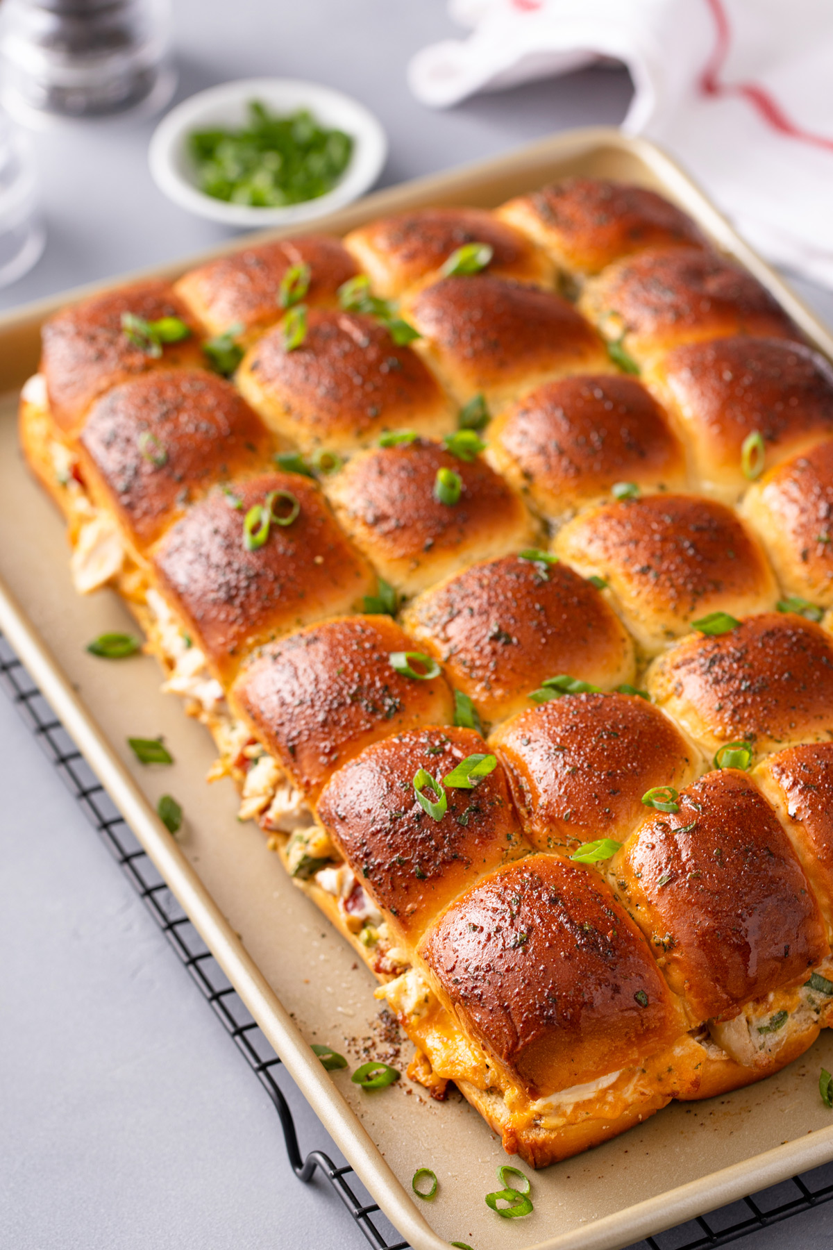 Baked chicken bacon ranch sliders on a rimmed baking sheet.