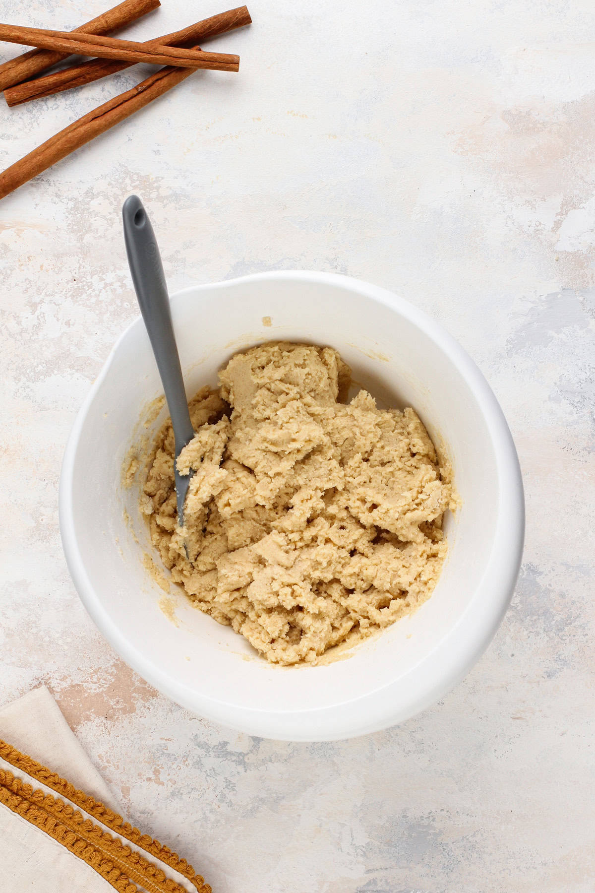 Brown butter snickerdoodle dough in a white bowl.