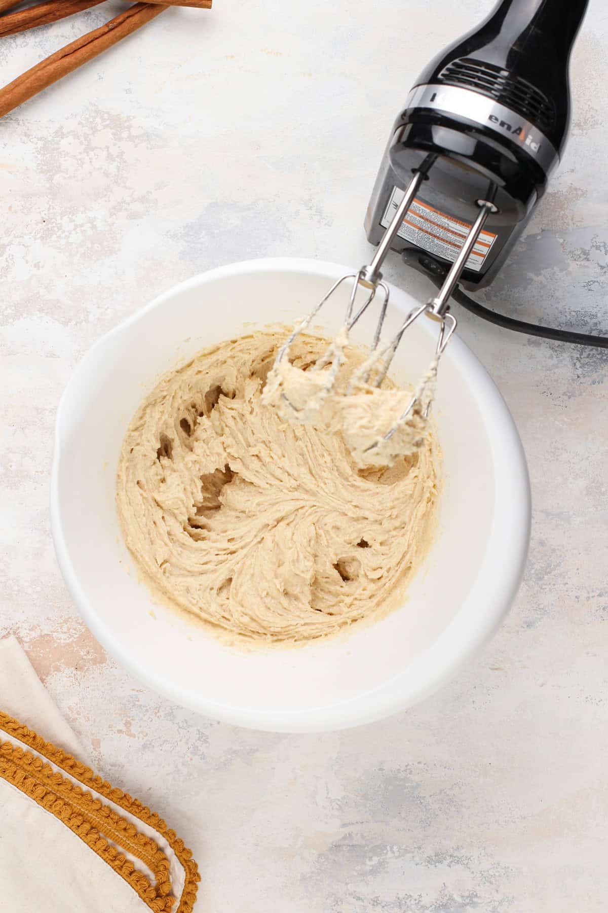 Wet ingredients for brown butter snickerdoodles mixed in a white bowl.