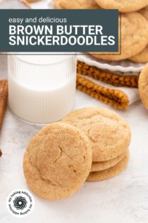 Four brown butter snickerdoodles stacked in front of a glass of milk. Text overlay includes recipe name.