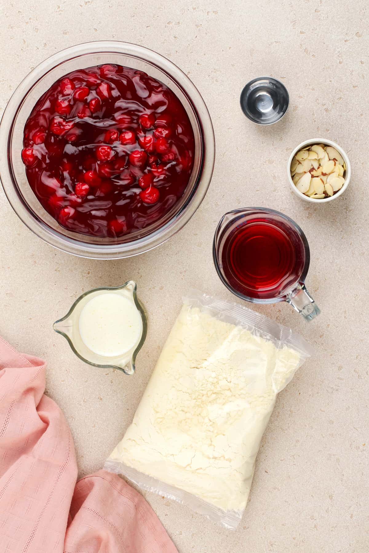 Cherry dump cake ingredients arranged on a countertop.