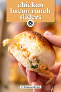 Hand holding a chicken bacon ranch slider up to the camera. Text overlay includes recipe name.