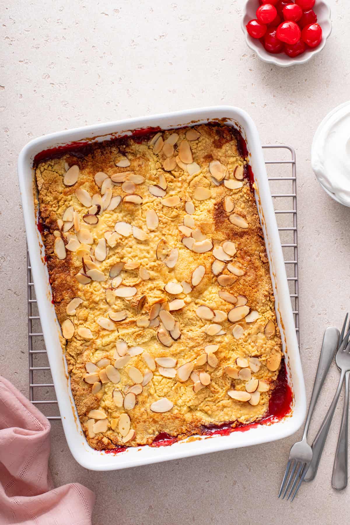 Cherry dump cake cooling on a wire rack.