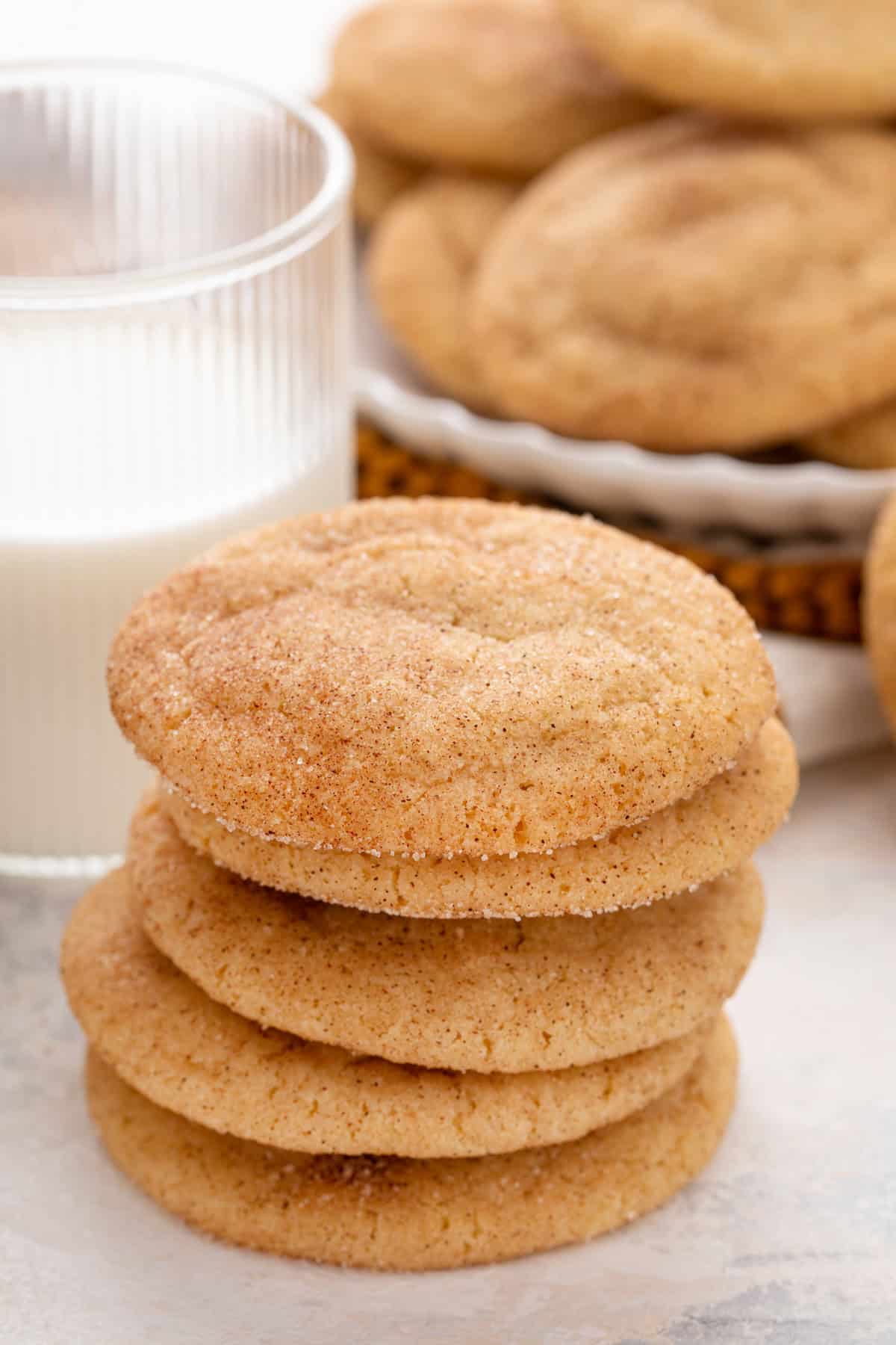 Close up of 5 brown butter snickerdoodles stacked on a countertop.