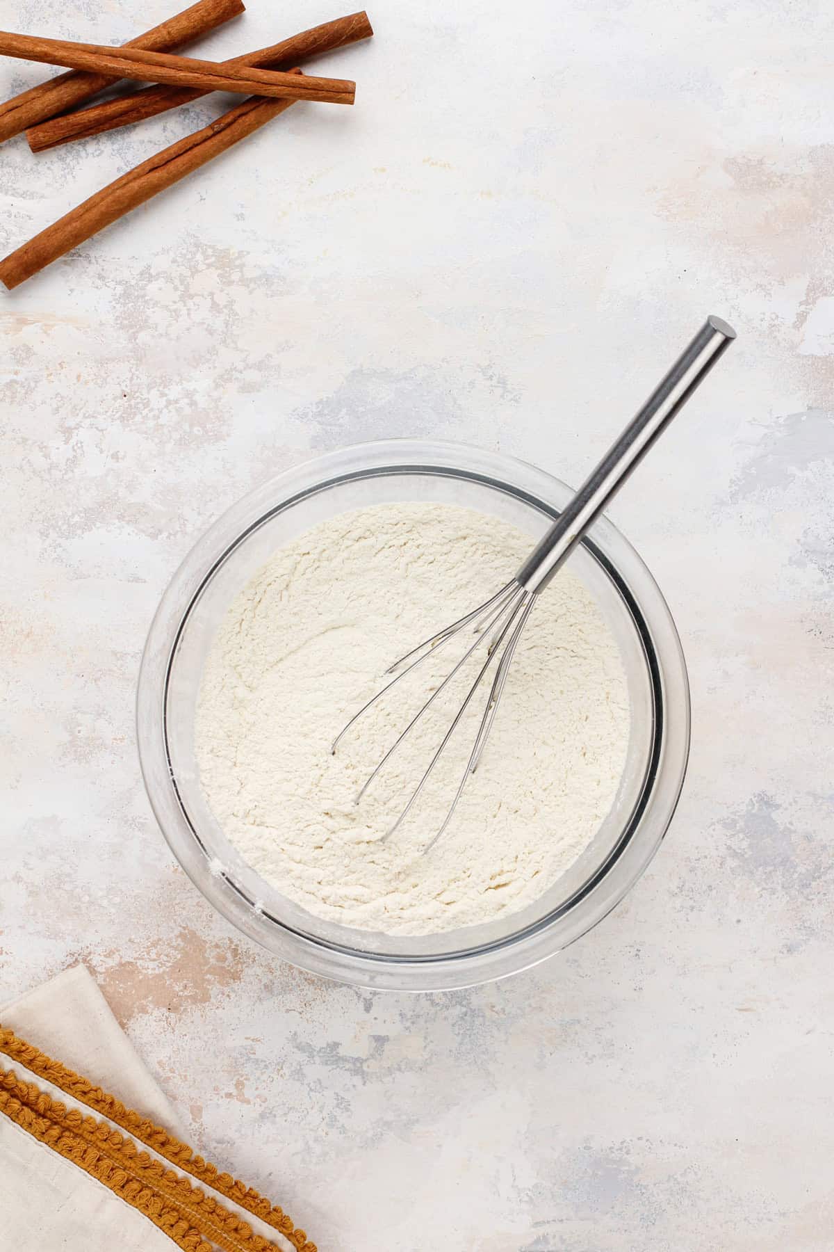 Dry ingredients whisked in a glass mixing bowl.