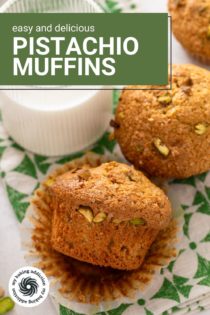 Two pistachio muffins next to a glass of milk on a green and white napkin. Text overlay includes recipe name.