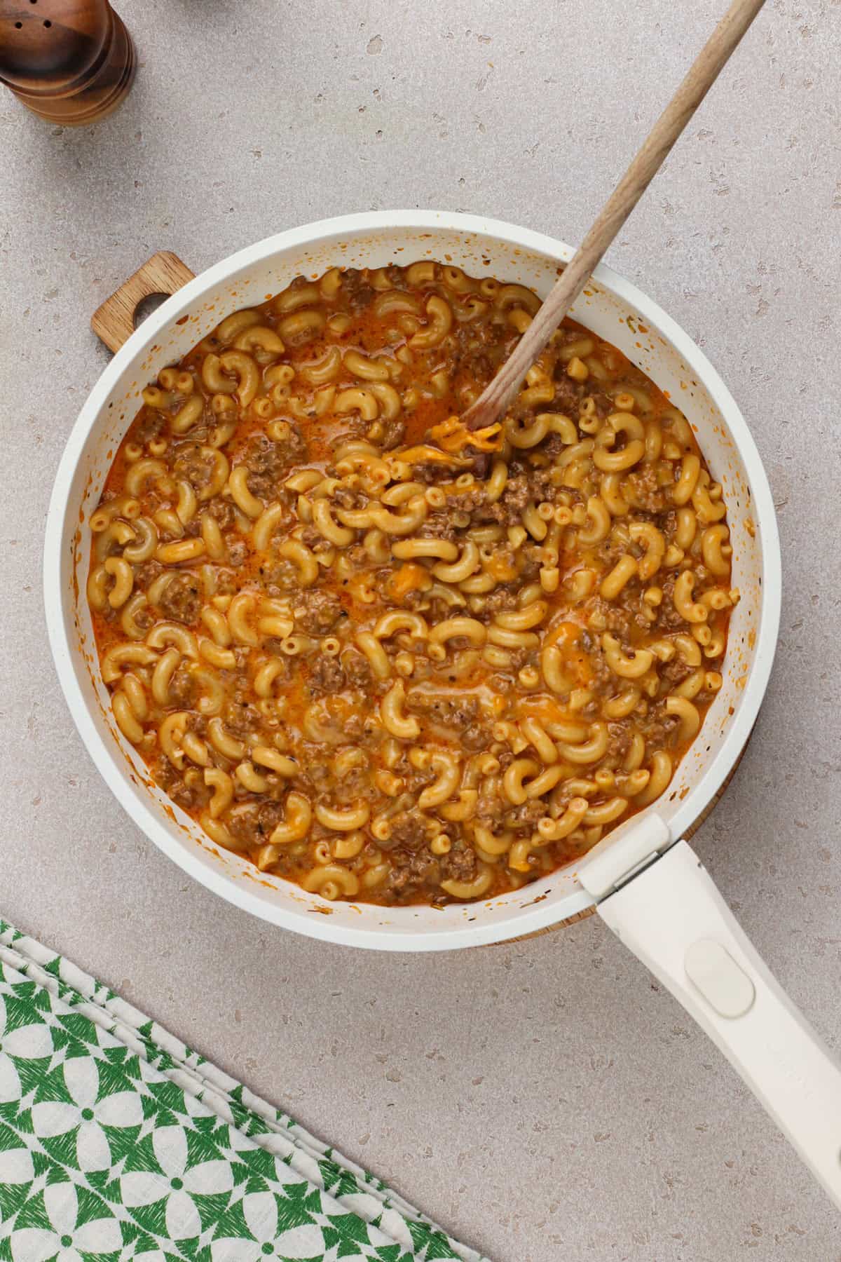 Cooked cheeseburger helper in a white skillet.