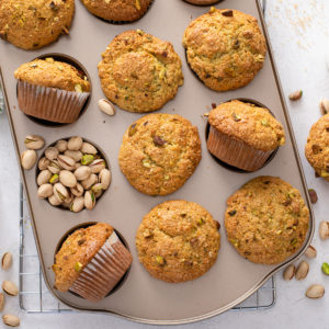 Cooled pistachio muffins arranged in a muffin tin.