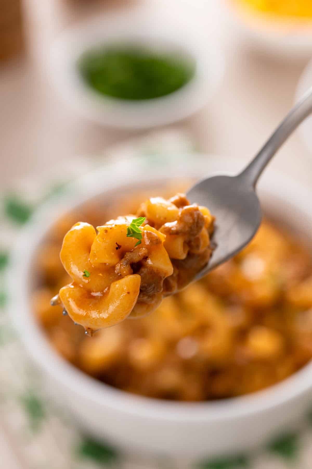 Fork holding up a bite of homemade cheeseburger helper.