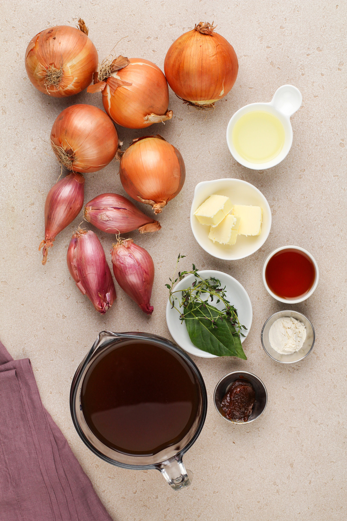 Ingredients for french onion soup arranged on a countertop.