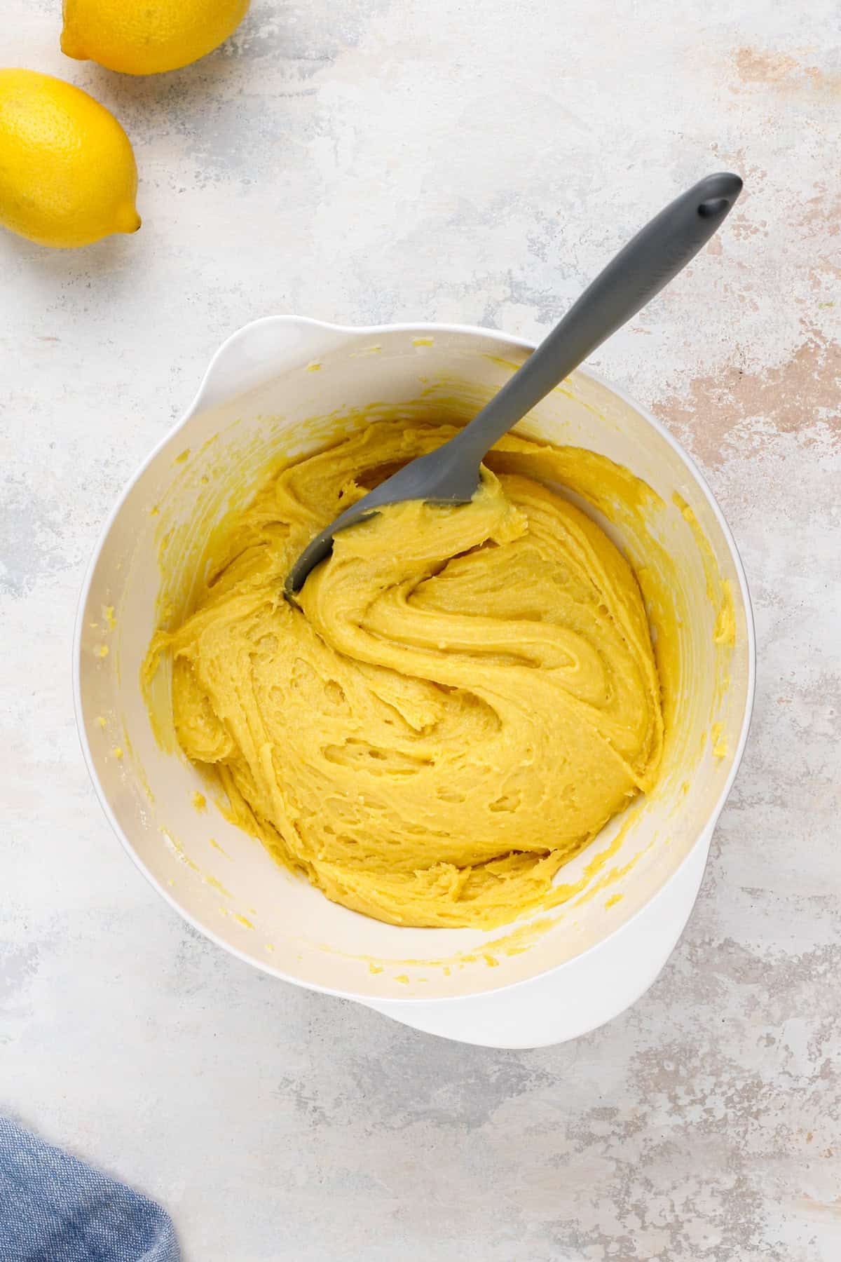 Lemon crinkle cookie dough in a white bowl.