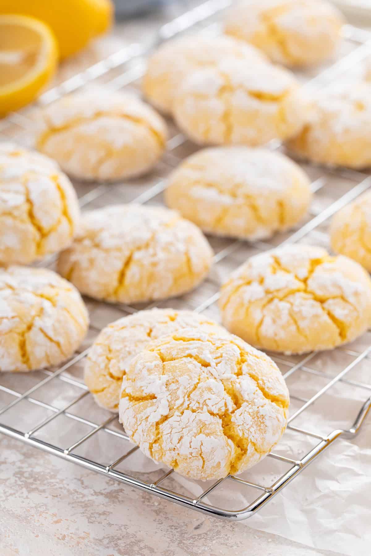 Lemon crinkle cookies arranged on a wire rack.