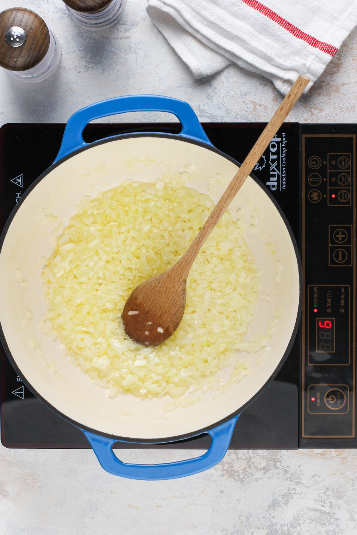 Diced onions cooking in a dutch oven.