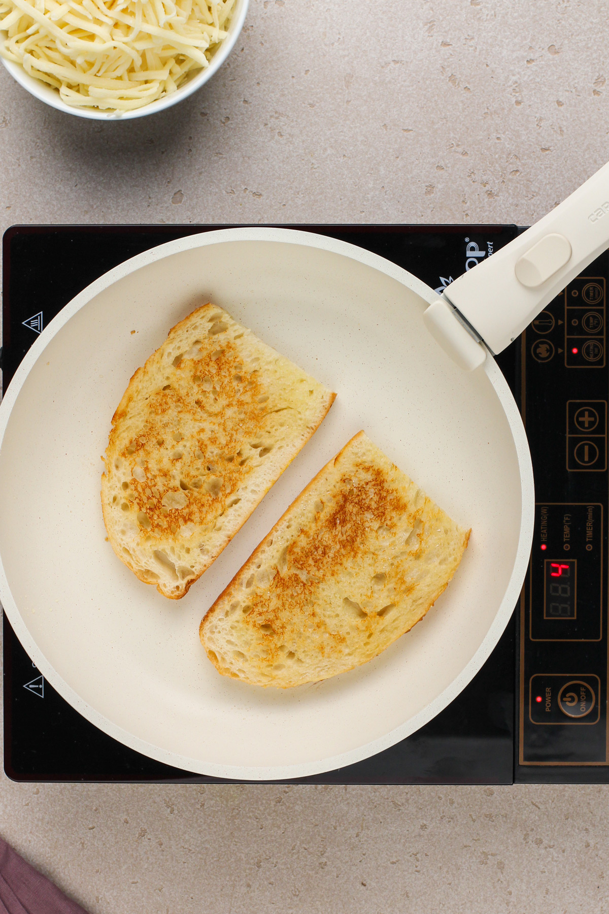 Two toasted slices of bread in a skillet.