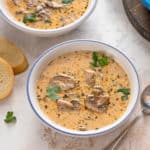 Creamy mushroom soup in a white bowl.