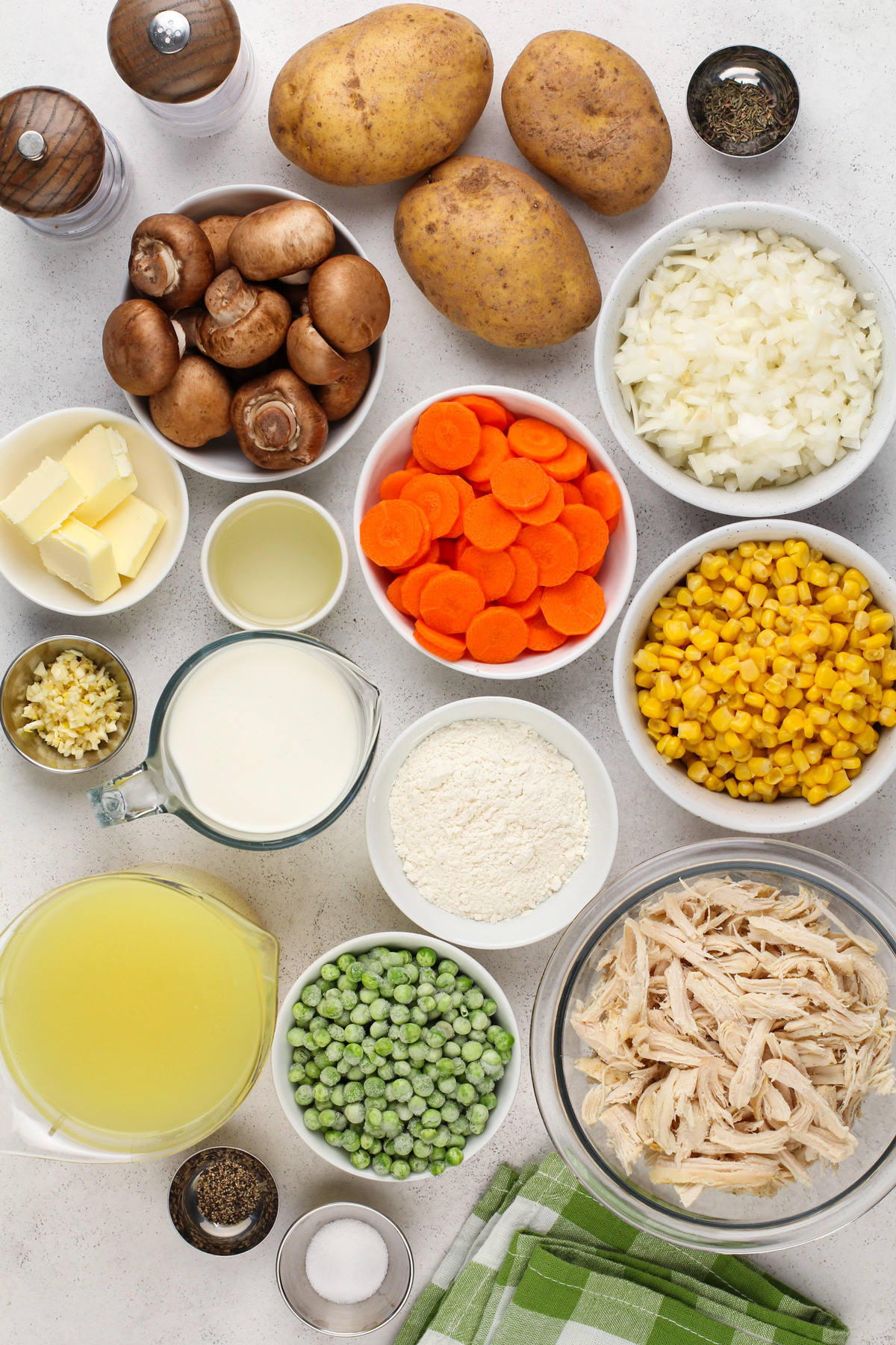 Ingredients for chicken pot pie soup arranged on a countertop.