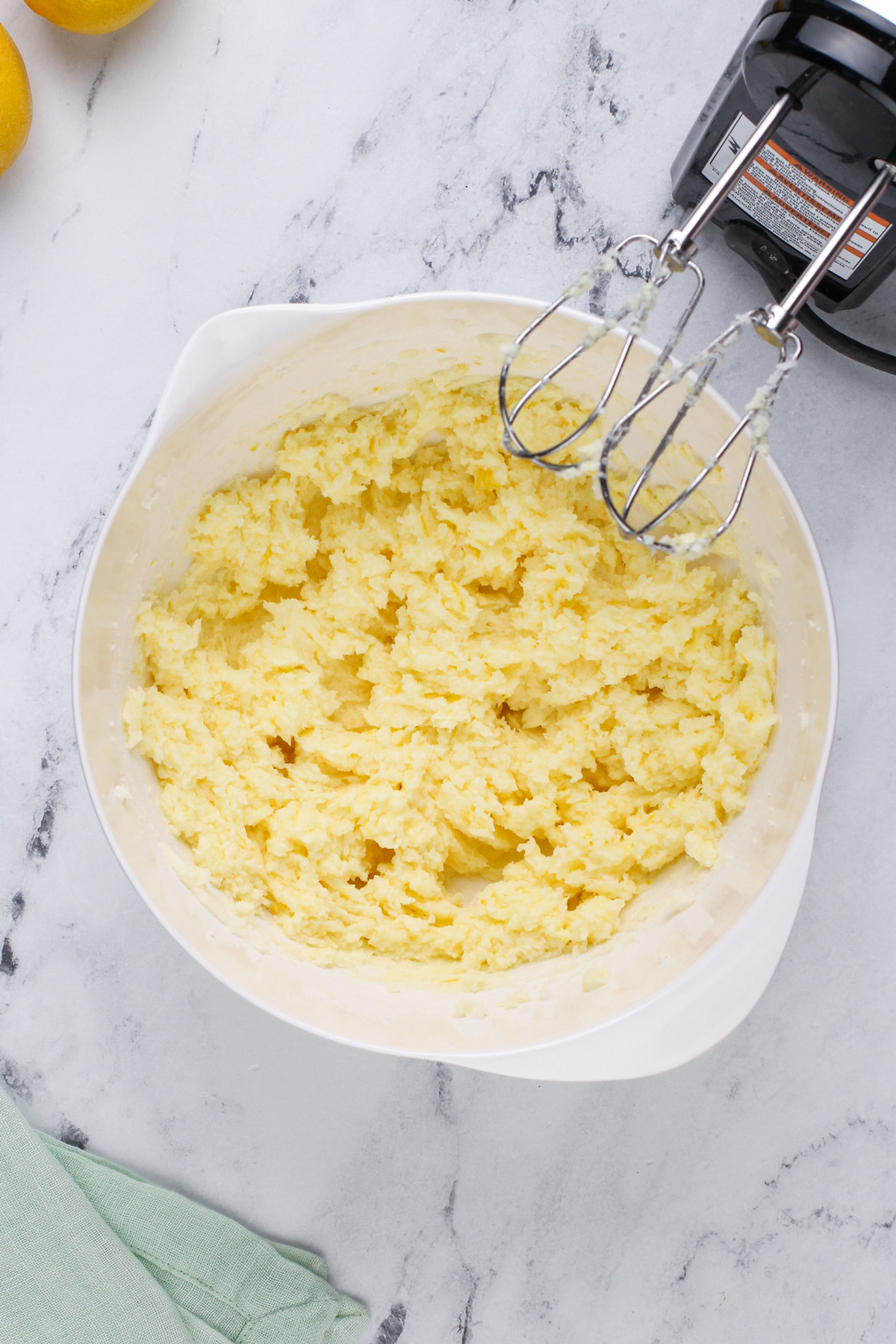 Wet ingredients for lemon cookies mixed in a white bowl.