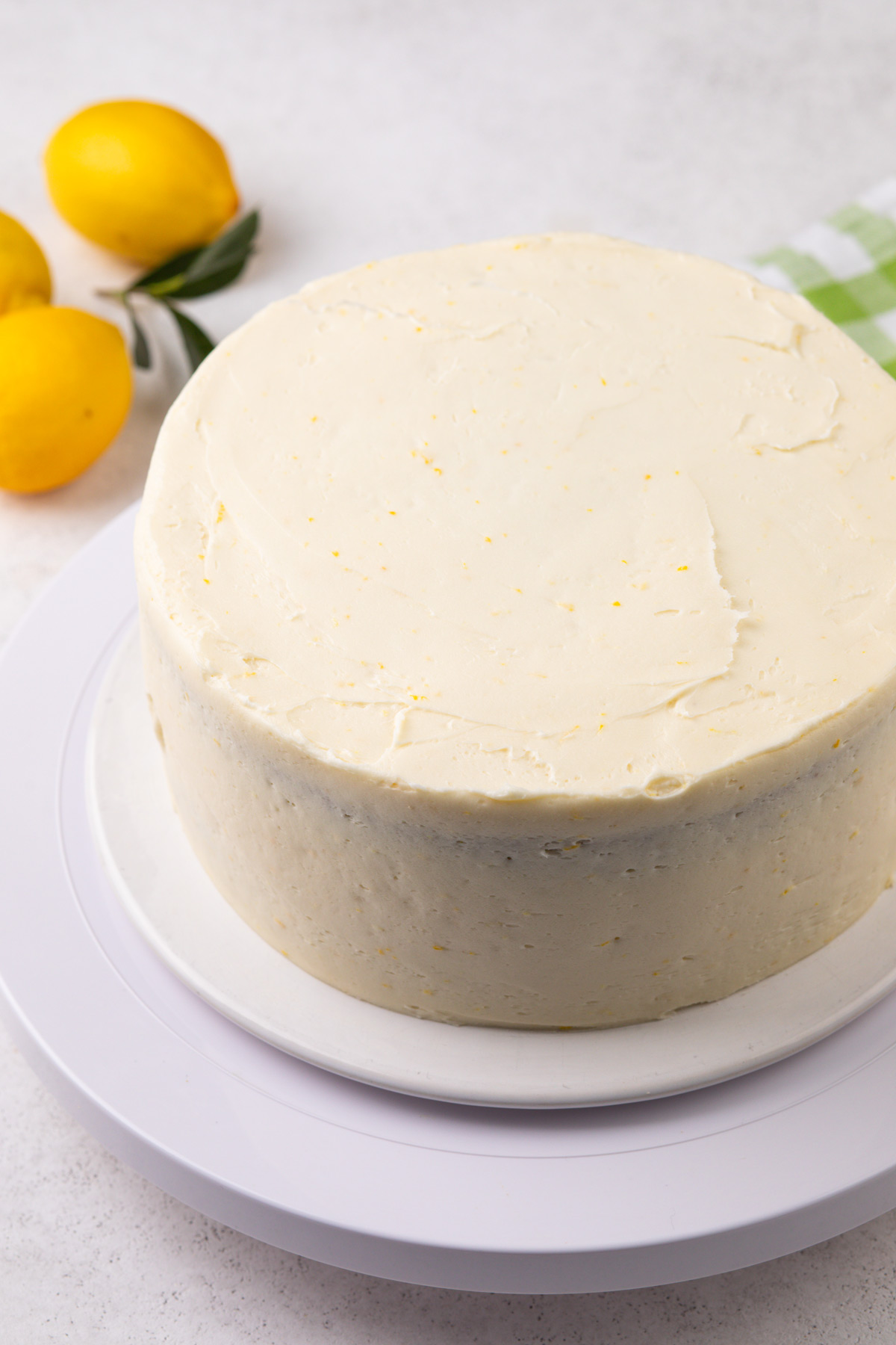 Lemon layer cake with frosting spread on the top and sides.