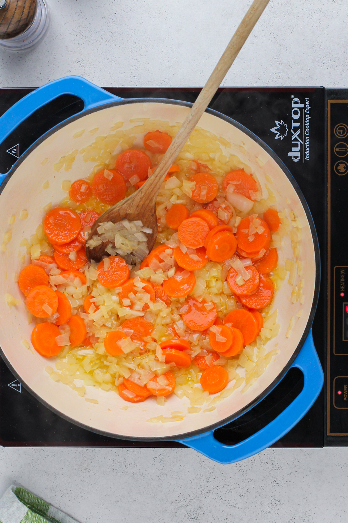 Sauteed onions and carrots in a dutch oven.