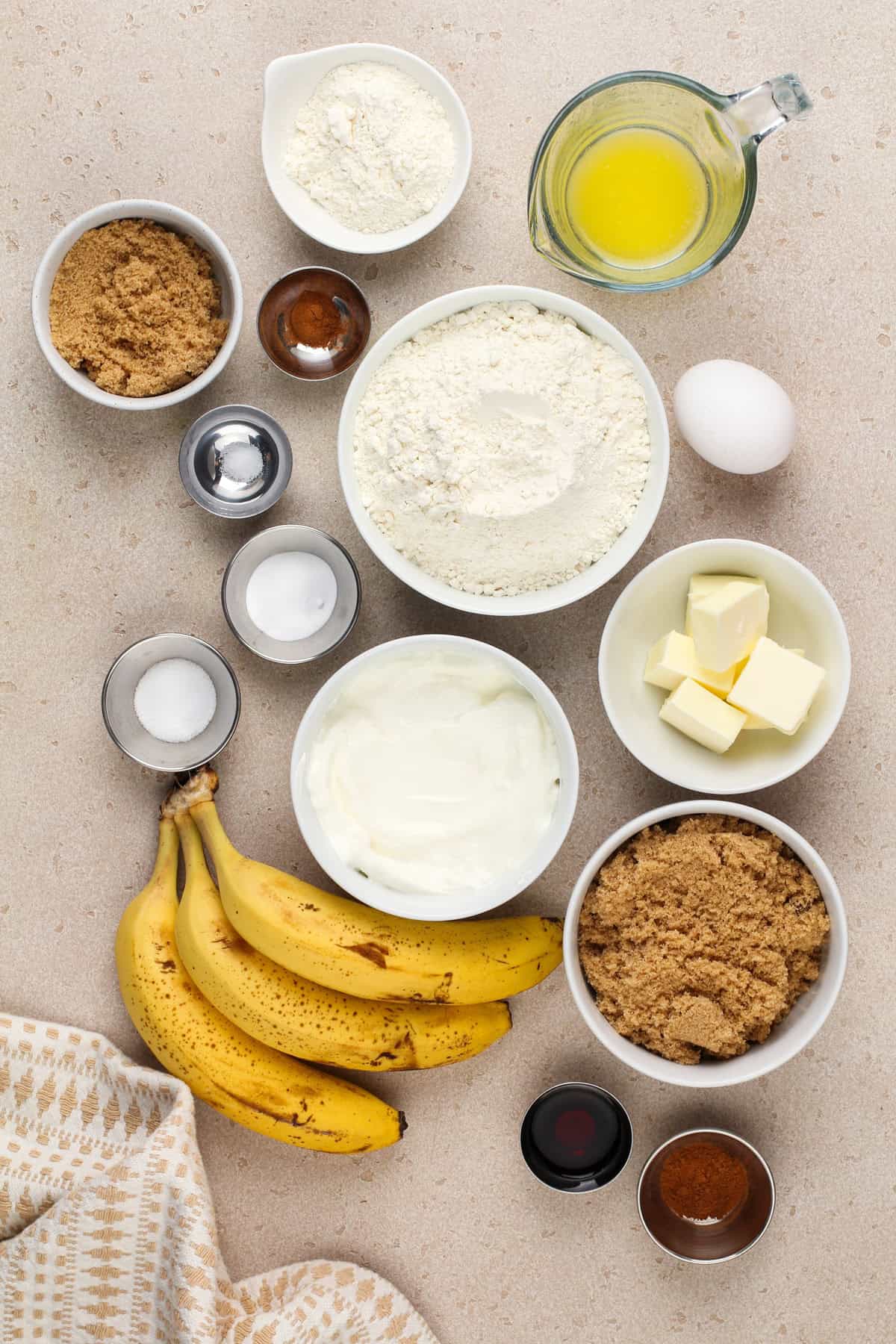 Ingredients for sour cream banana bread arranged on a countertop.