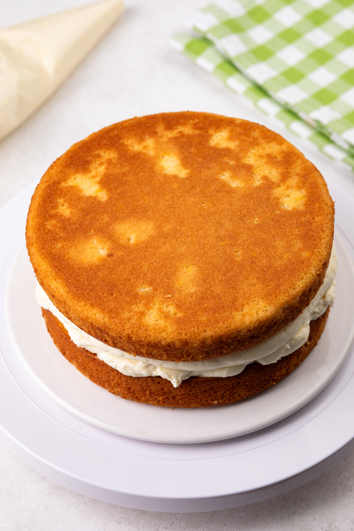 Stacked layers of lemon cake, ready to be frosted on the top and sides.