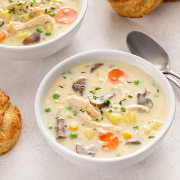 Chicken pot pie soup in a white bowl.