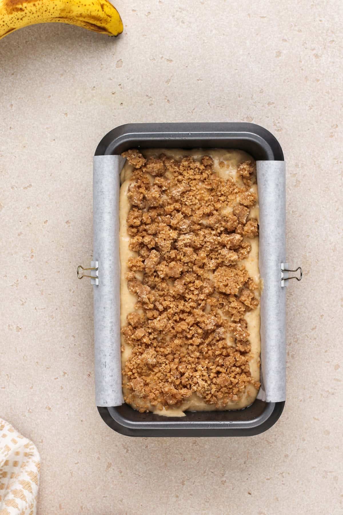 Sour cream banana bread assembled in a loaf pan, ready to go in the oven.